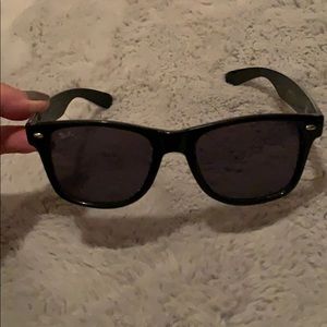 Black ray bans with blue writhing on the sides